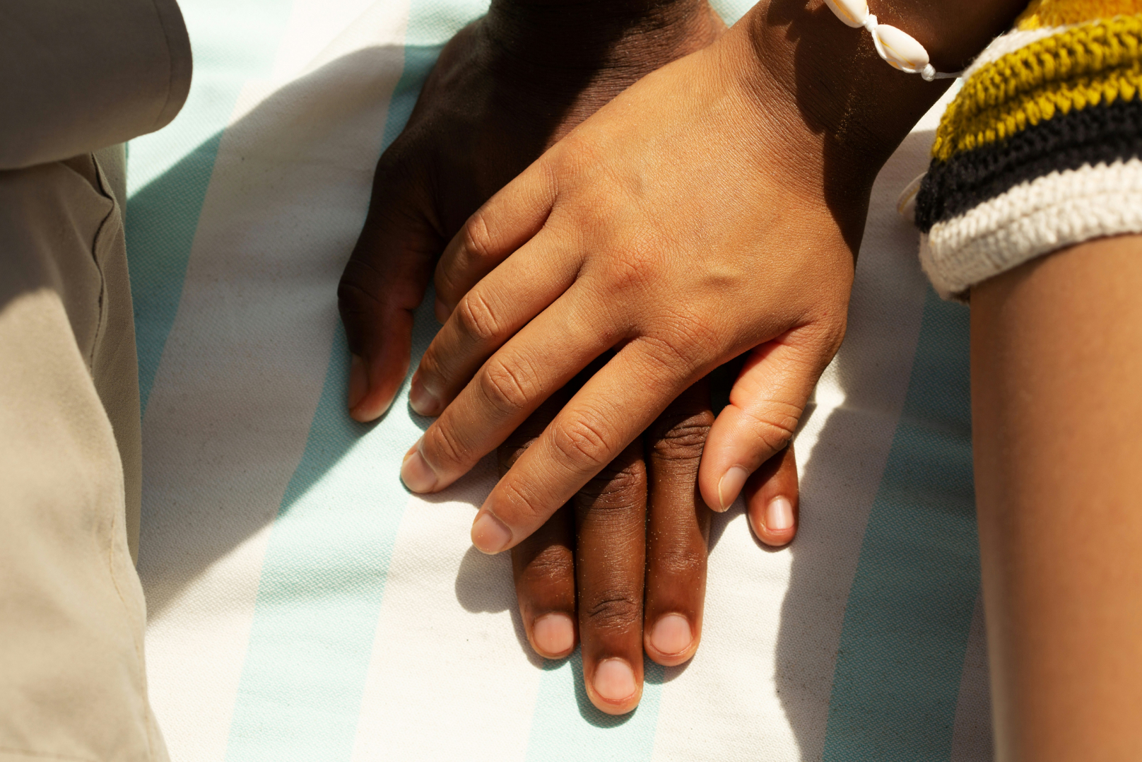 Close-up of couple holding hands, symbolizing love and partnership
